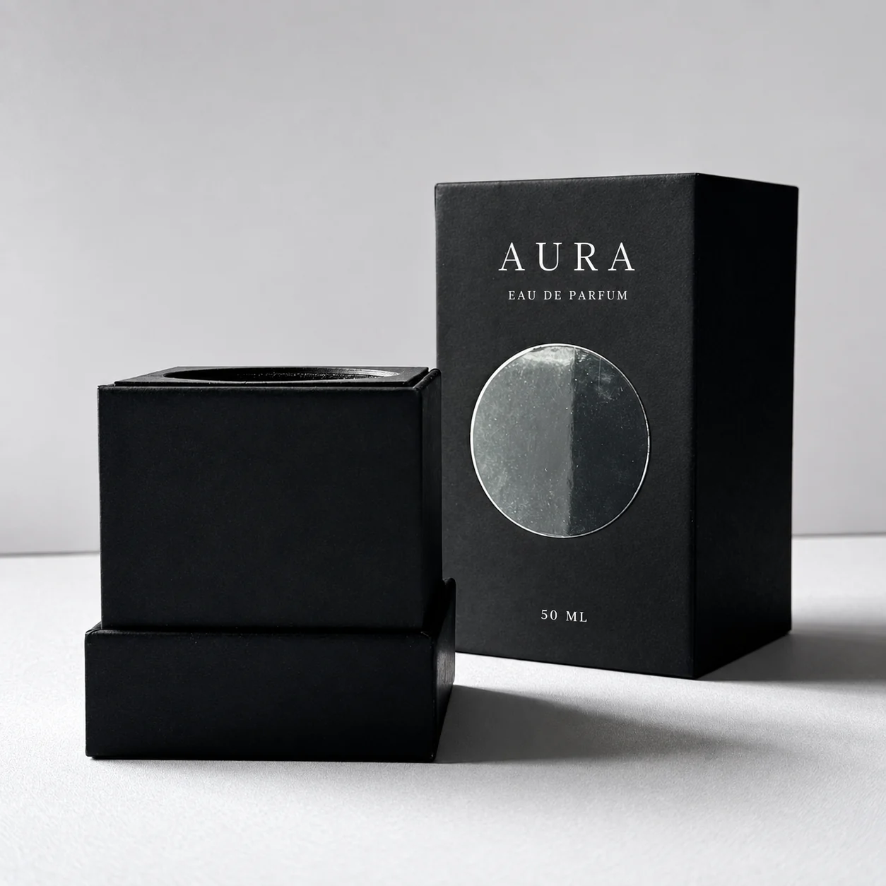 Black rigid perfume box with silver circular detail