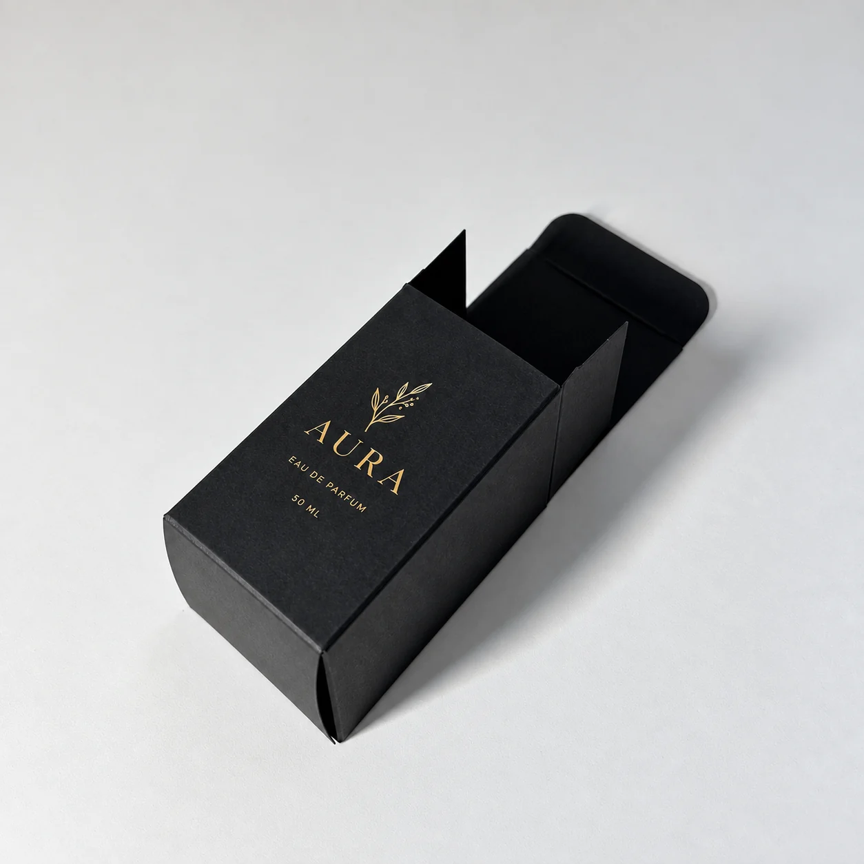 Closed black folding perfume carton with gold printing