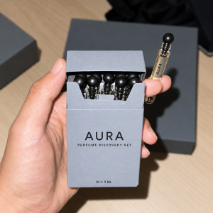 Open gray flip-top perfume discovery set box with ten sample vials