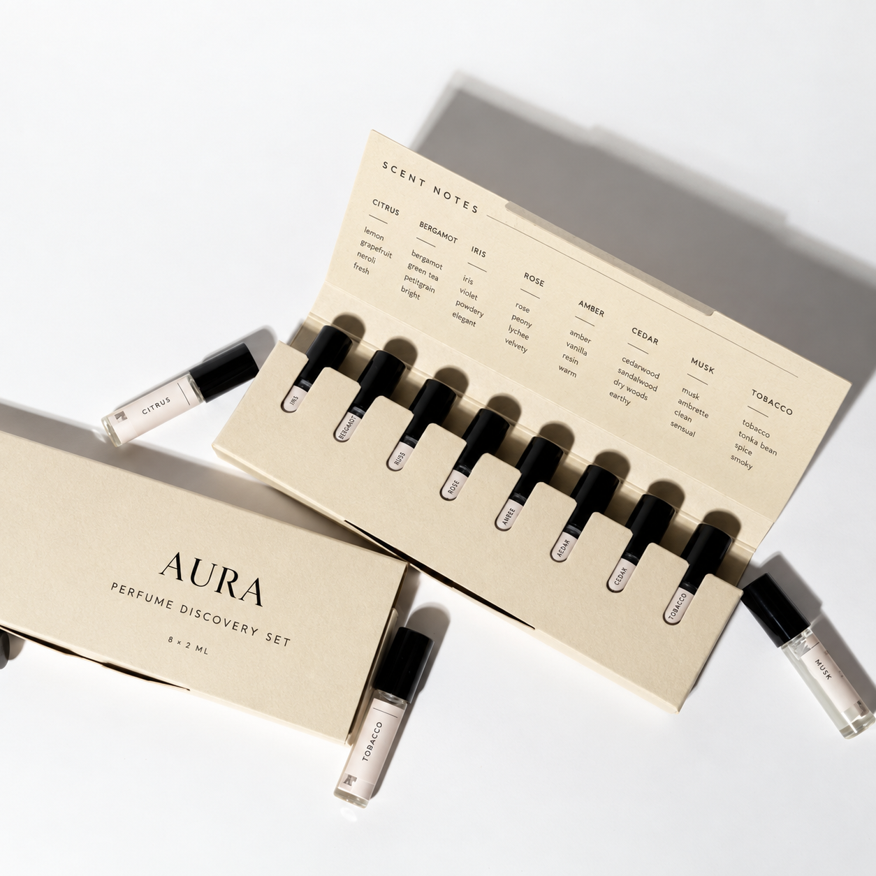 Open ivory perfume discovery box with eight 2ml vials and scent notes