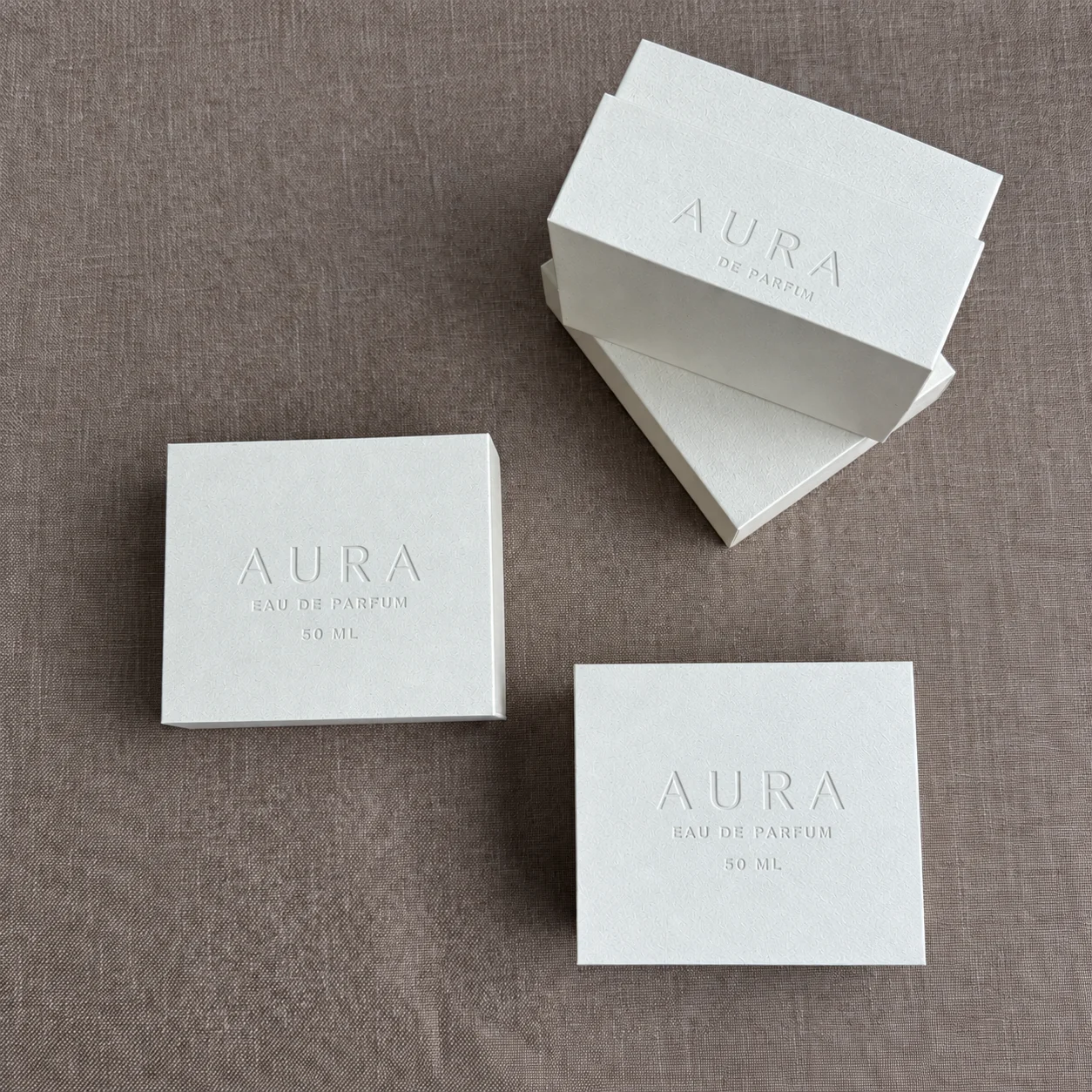 Ivory rigid perfume boxes with tonal debossed logo