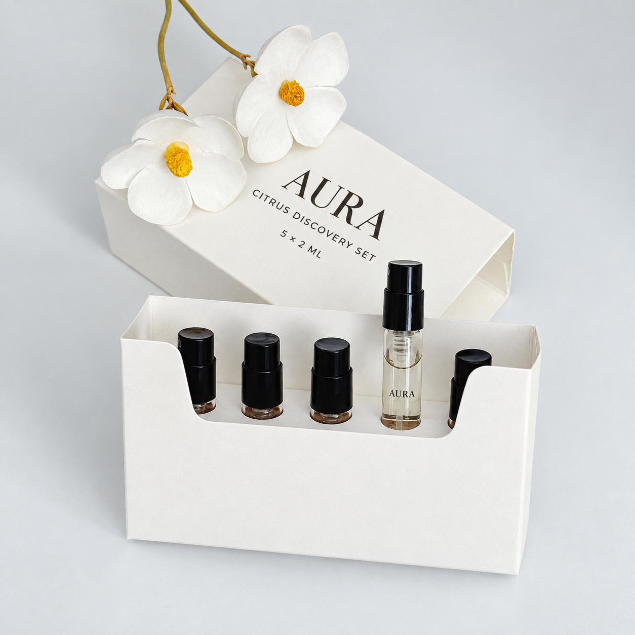 Open ivory sliding perfume discovery set box with five sample vials