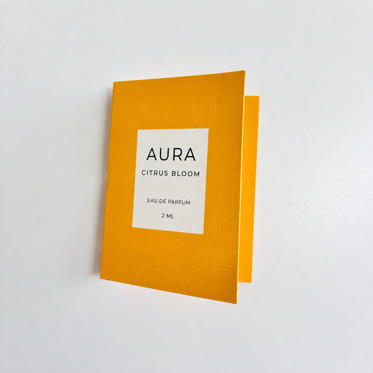 Closed orange folding perfume sample card