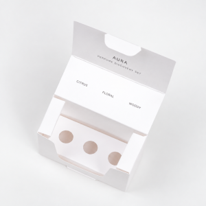 Open white folding perfume discovery box with three vial insert holes