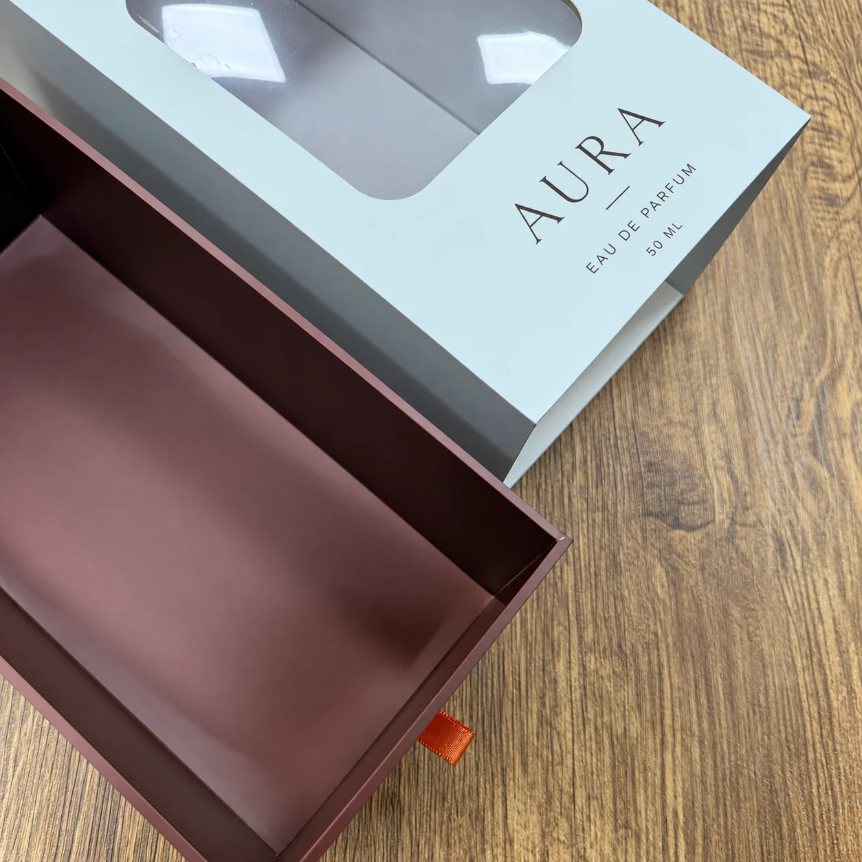 White window sleeve and burgundy perfume box drawer detail
