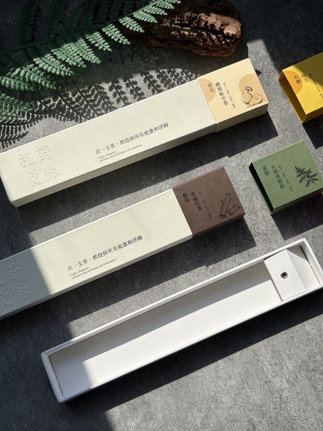 Ivory Sliding Incense Box with Paper Tray: long ivory paper tray with an end support and metal eyelet