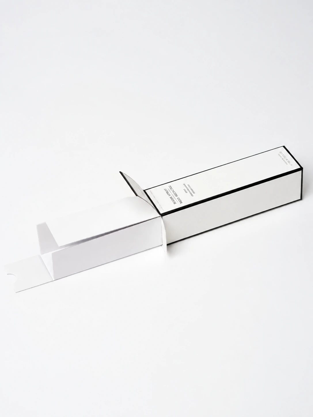 A paper insert pulled out from a black-edged room spray carton