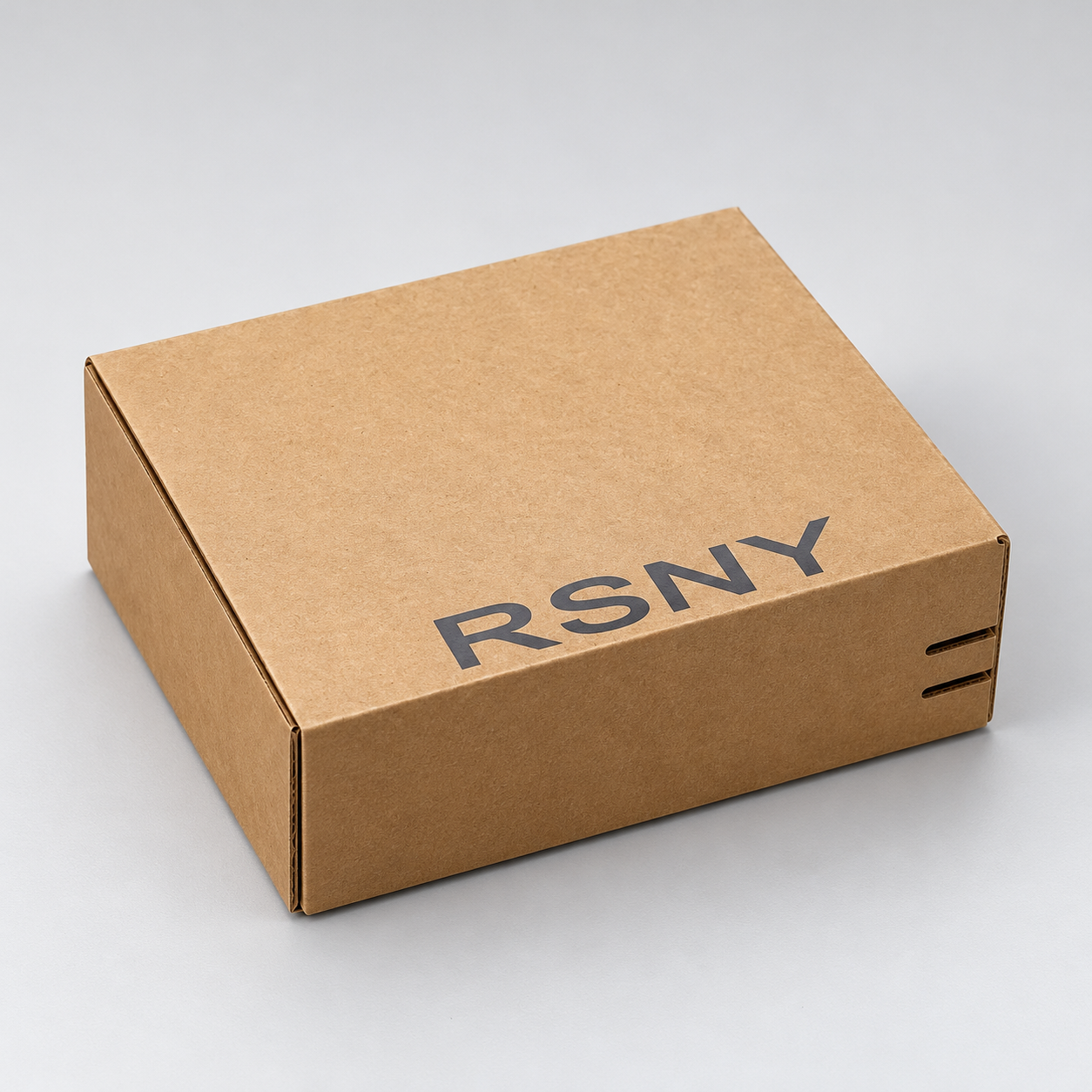 Kraft Tear-Strip Shipping Box with Black Wordmark: closed kraft shipping box with a black wordmark