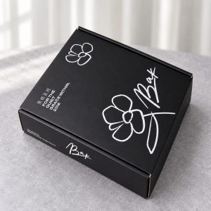 Black Floral Print Mailer Box with White Interior: closed box showing the exterior printing and lid