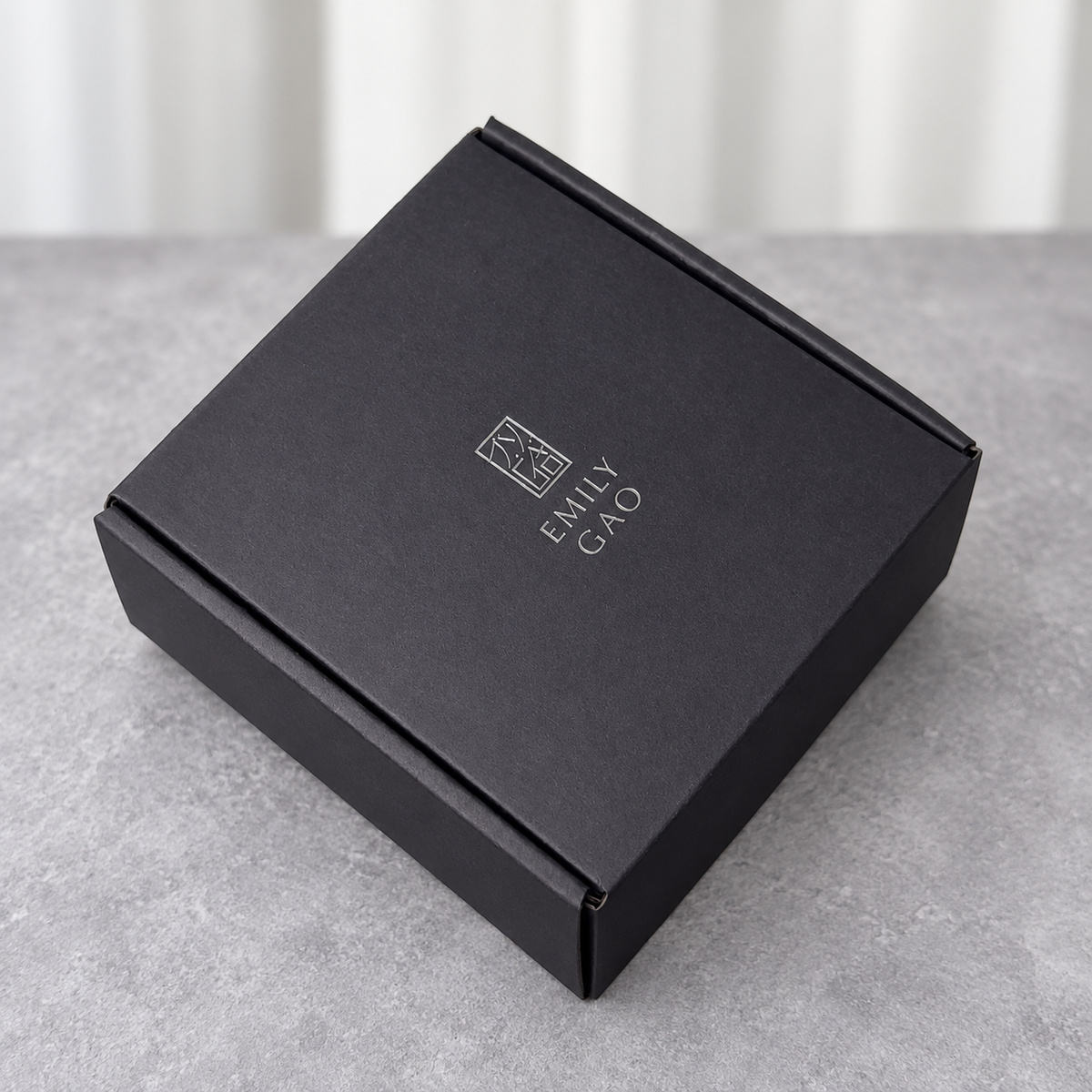 Charcoal Mailer Box with Silver-Tone Logo: closed box showing the exterior printing and lid