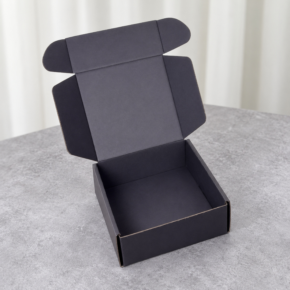 Charcoal Mailer Box with Silver-Tone Logo: open box showing the interior and folding lid structure