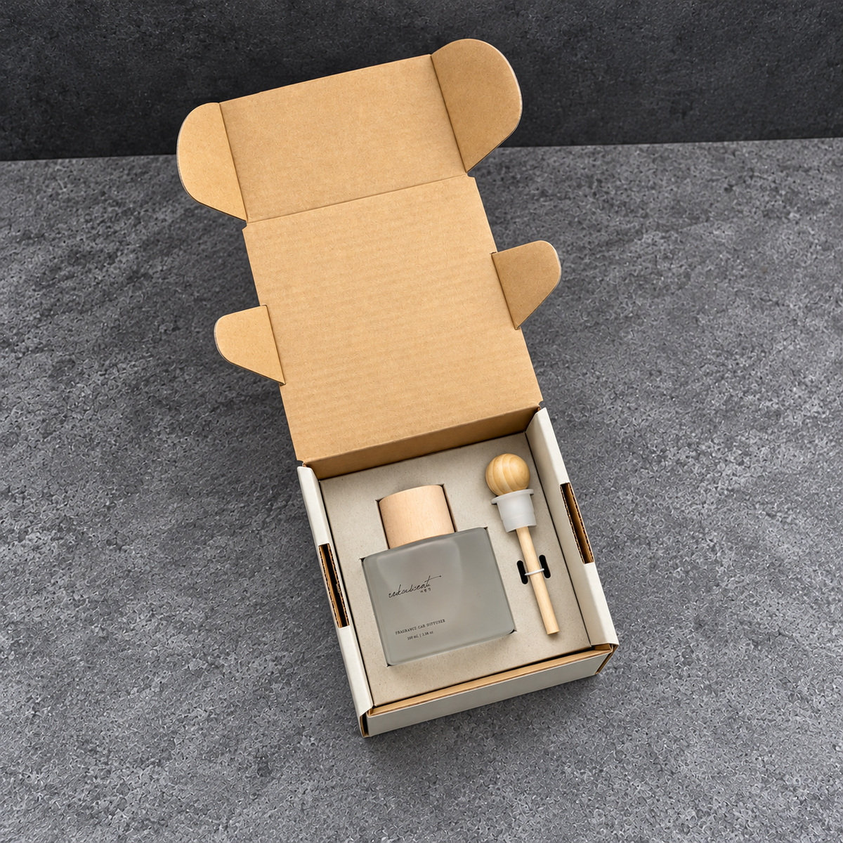 Open cream mailer with kraft interior and a fitted bottle-and-accessory paper tray