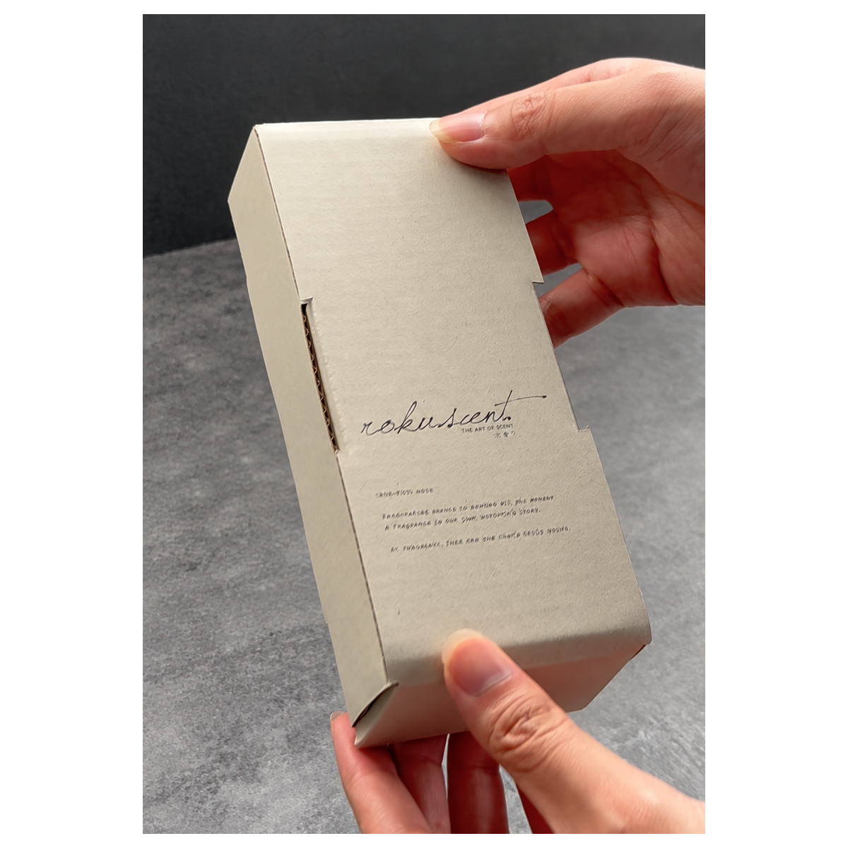 Open cream long mailer box with a spray bottle seated in a fitted paper insert