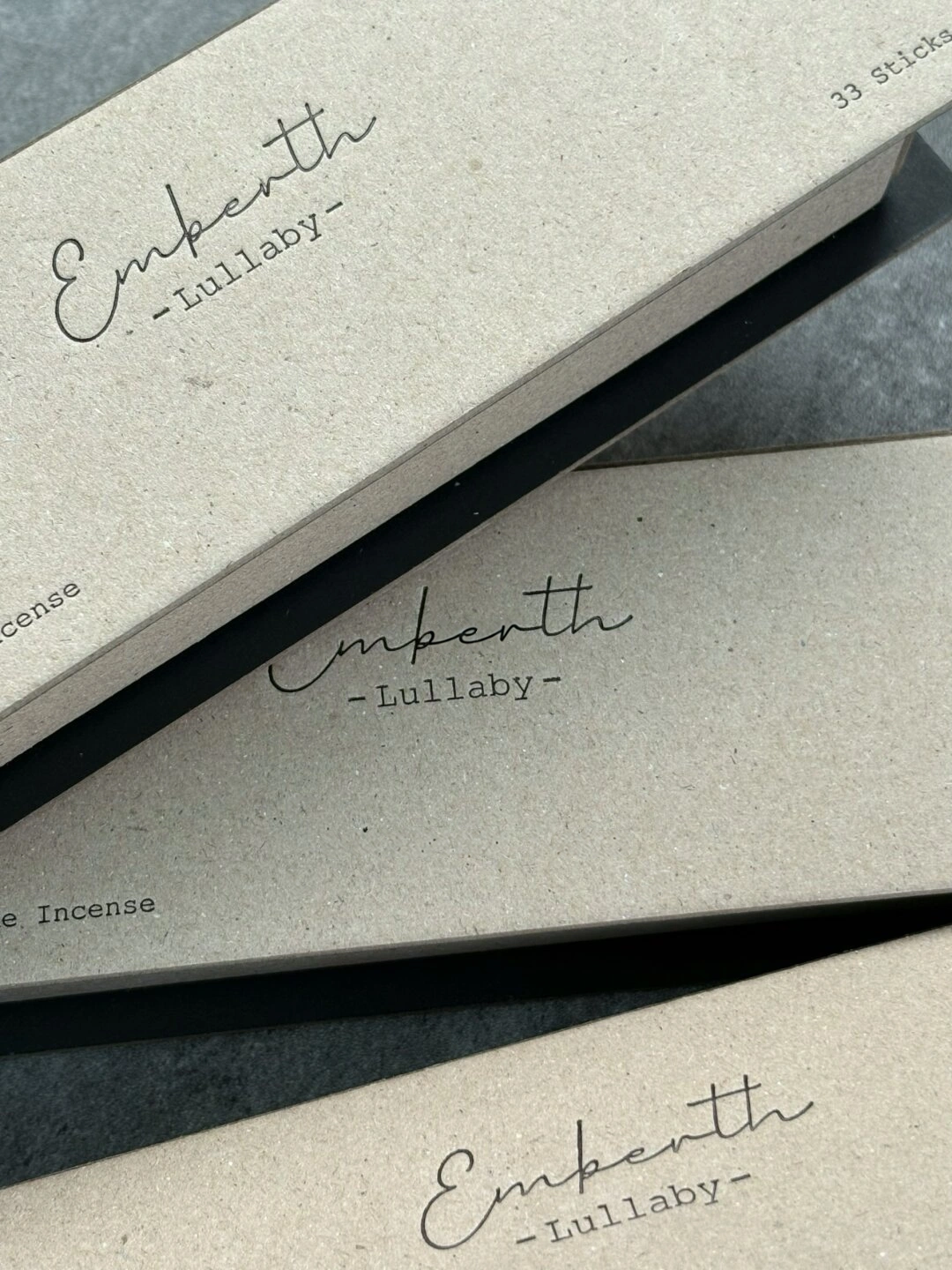 Natural Paper Book-Style Incense Box with Black Insert: close-up of the original script lettering and flecked paper surface