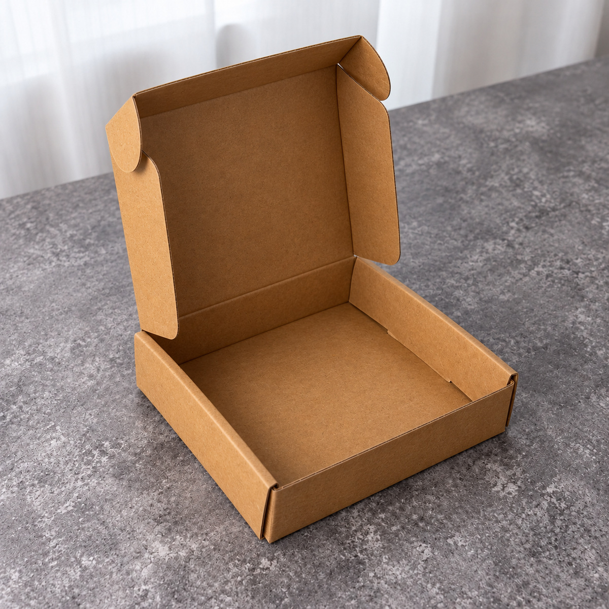 Inside of the kraft mailer unfolded flat with die-cut tabs and fold lines