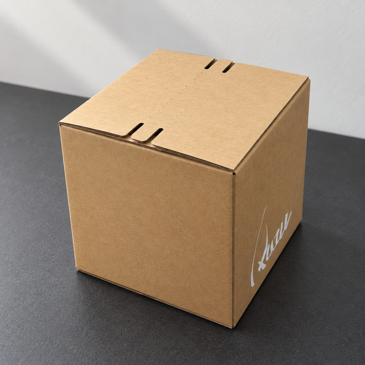 Closed kraft corrugated shipping box with interlocking top flaps and white side branding