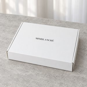 Minimal White Mailer Box with Black Base Interior: closed box showing the exterior printing and lid
