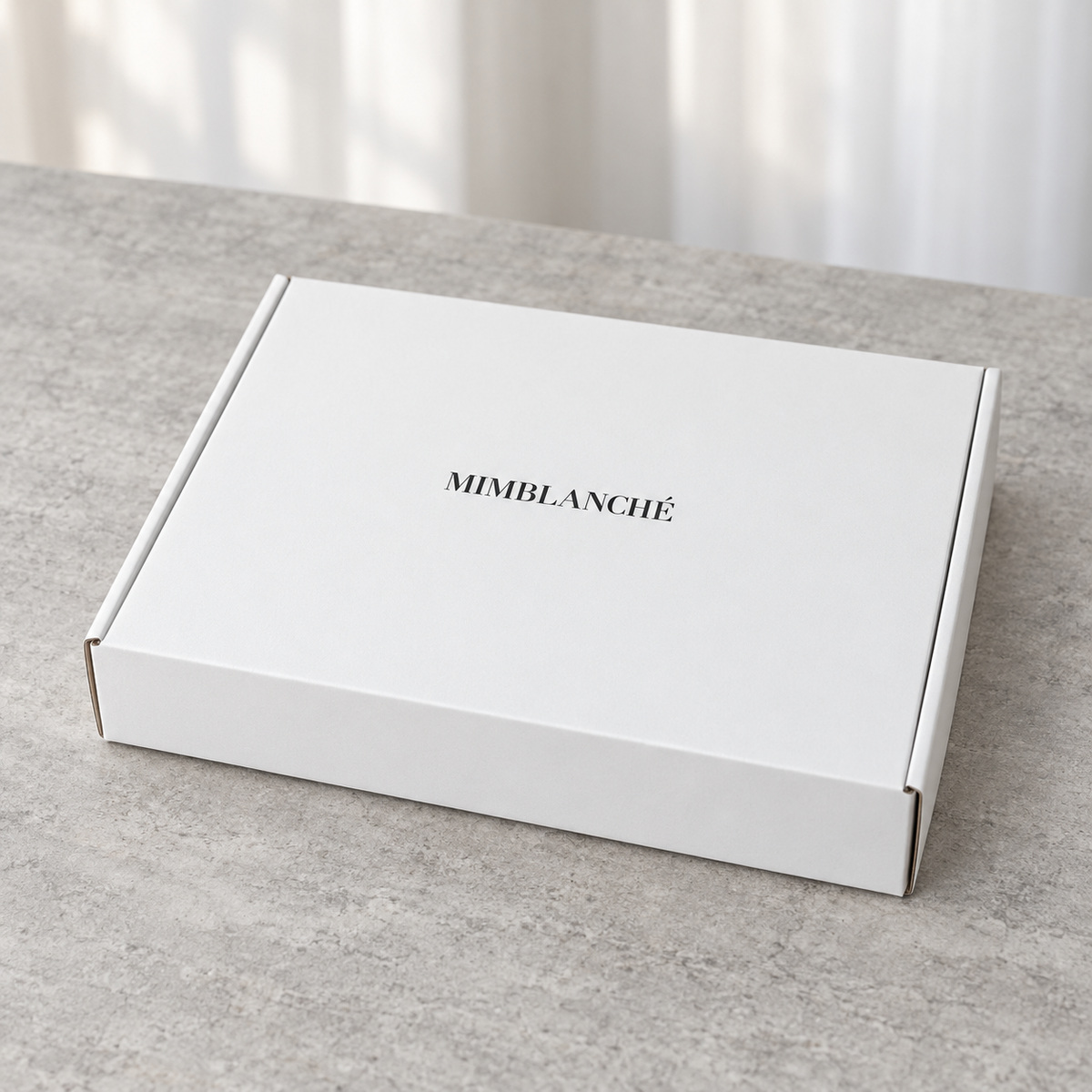 Minimal White Mailer Box with Black Base Interior: closed box showing the exterior printing and lid