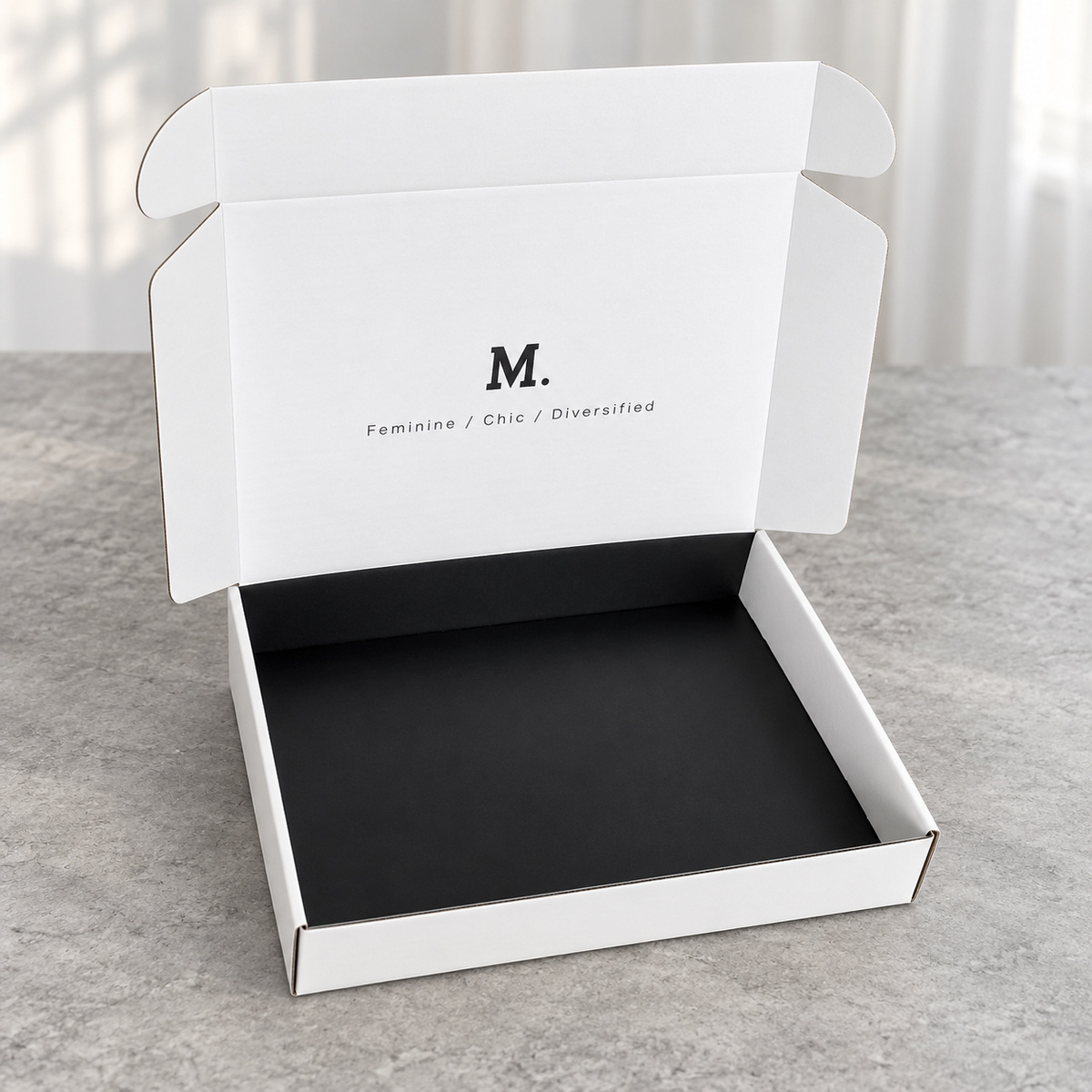 Minimal White Mailer Box with Black Base Interior: open box showing the interior and folding lid structure