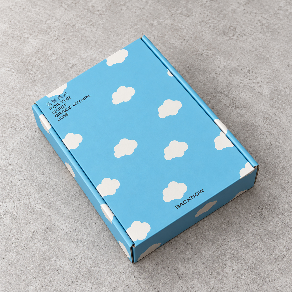 Sky Blue Cloud Print Fold-Flat Mailer Box: closed box showing the exterior printing and lid