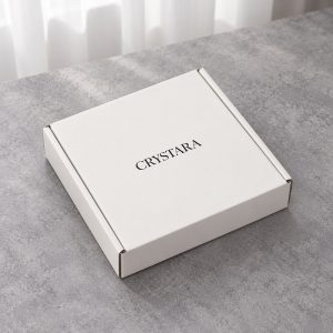 Closed white mailer box with dark logo on the lid