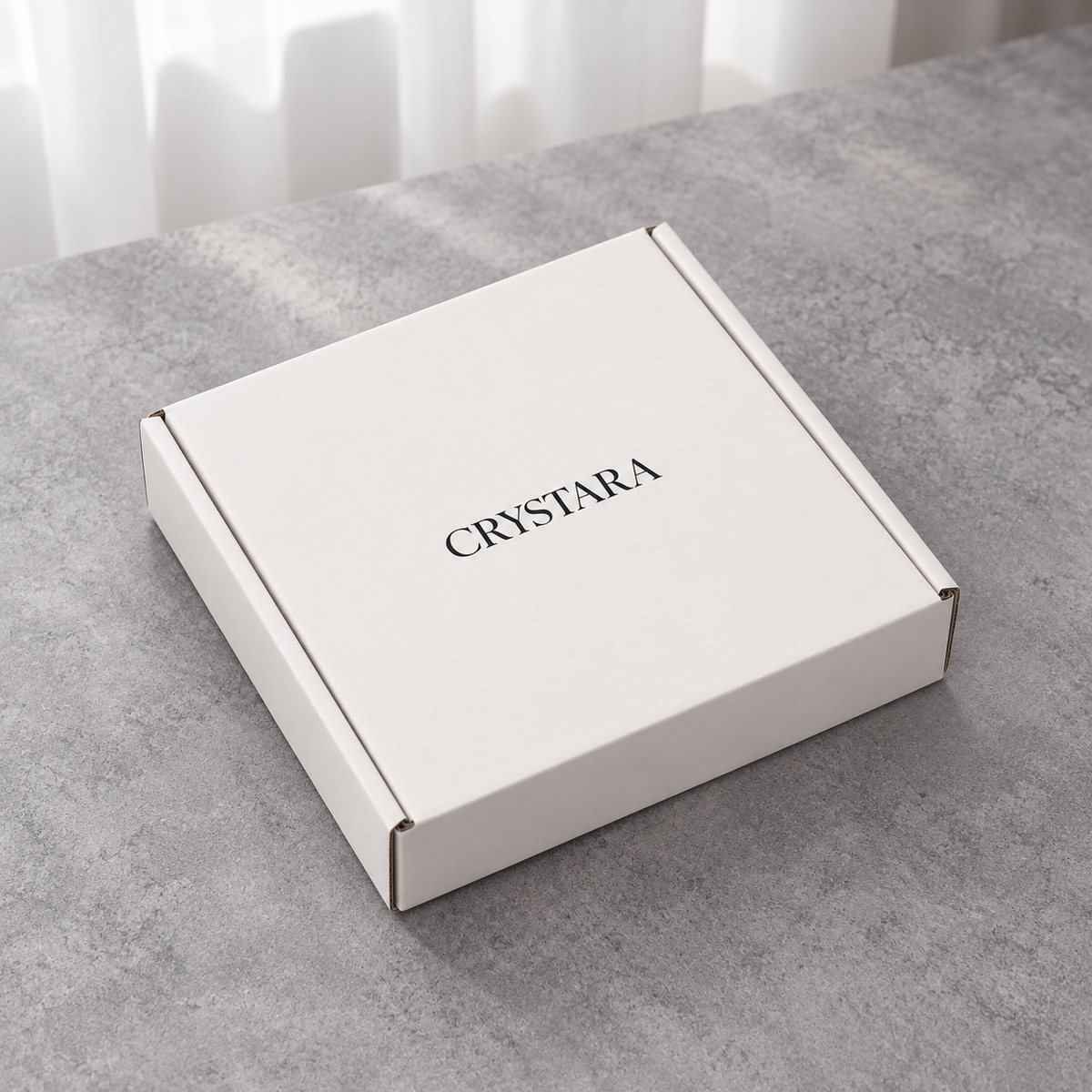 Closed white mailer box with dark logo on the lid